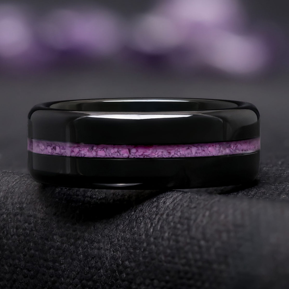 Flat black tungsten ring with a thin real crushed purple turquoise inlay, straight-on front view