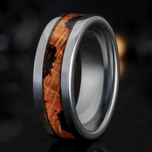 Men's 8mm silver tungsten band with whiskey barrel wood and coffee grinds inlay, standing at an angle