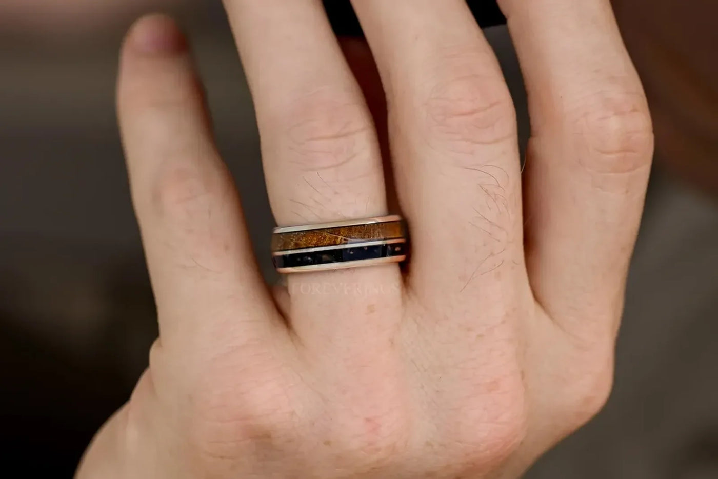 Mens wedding band with real wood inlay worn on his hand
