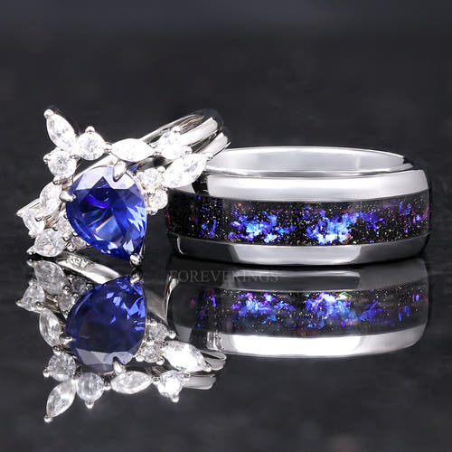 Matching couples ring set: sapphire bridal set leaning on a wider silver band with nebula inlay