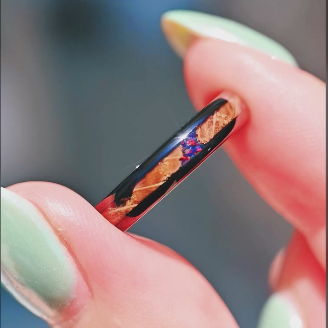 Men’s black tungsten wedding ring with fire opal and whiskey barrel