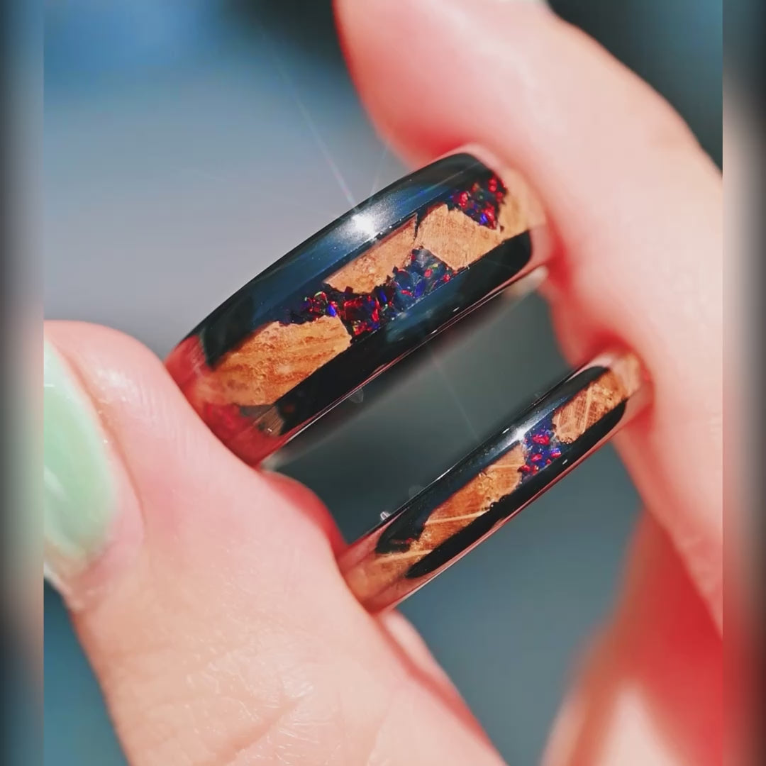 His and her black tungsten wedding bands with fire opal and whiskey barrel