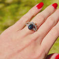 Silver couples ring set with black fire opal, her oval ring and his 8mm polished tungsten band turning in the light