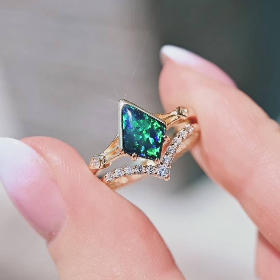 Gold Celtic kite opal engagement ring set with blue green emerald opal