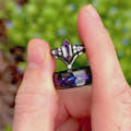 Black couples ring set with her kite alexandrite ring and his galaxy tungsten band, turning in the light