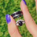 Silver couples ring set with black fire opal, her oval ring and his 8mm hammered tungsten band turning in the light