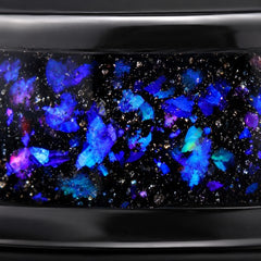 Close-up of crushed opal nebula inlay in a polished black tungsten band