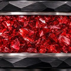 Close-up of crushed red garnet inlay in a faceted black tungsten band