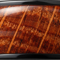 Close-up of whiskey barrel oak inlay in a black tungsten band