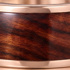 Close-up of koa wood inlay in a rose gold tungsten band