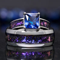 His and hers engagement rings in silver with Orion nebula inlays, her sapphire ring behind his band