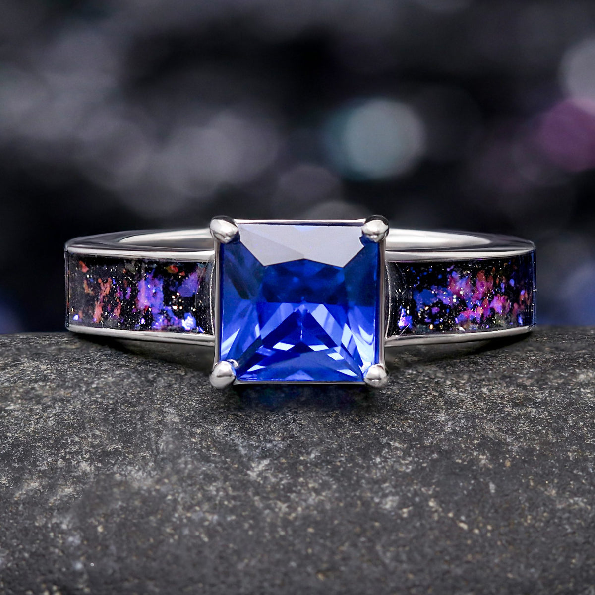 Women's sterling silver engagement ring with a princess cut blue sapphire and Orion nebula inlay, front view