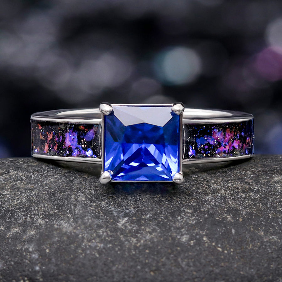 Women's sterling silver engagement ring with a princess cut blue sapphire and Orion nebula inlay, front view