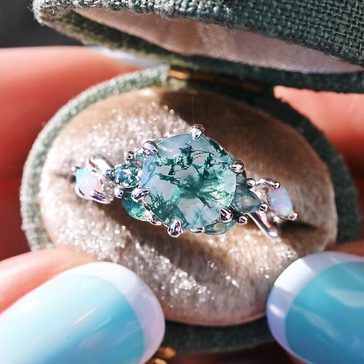 Sterling silver moss agate engagement ring in an open velvet ring box