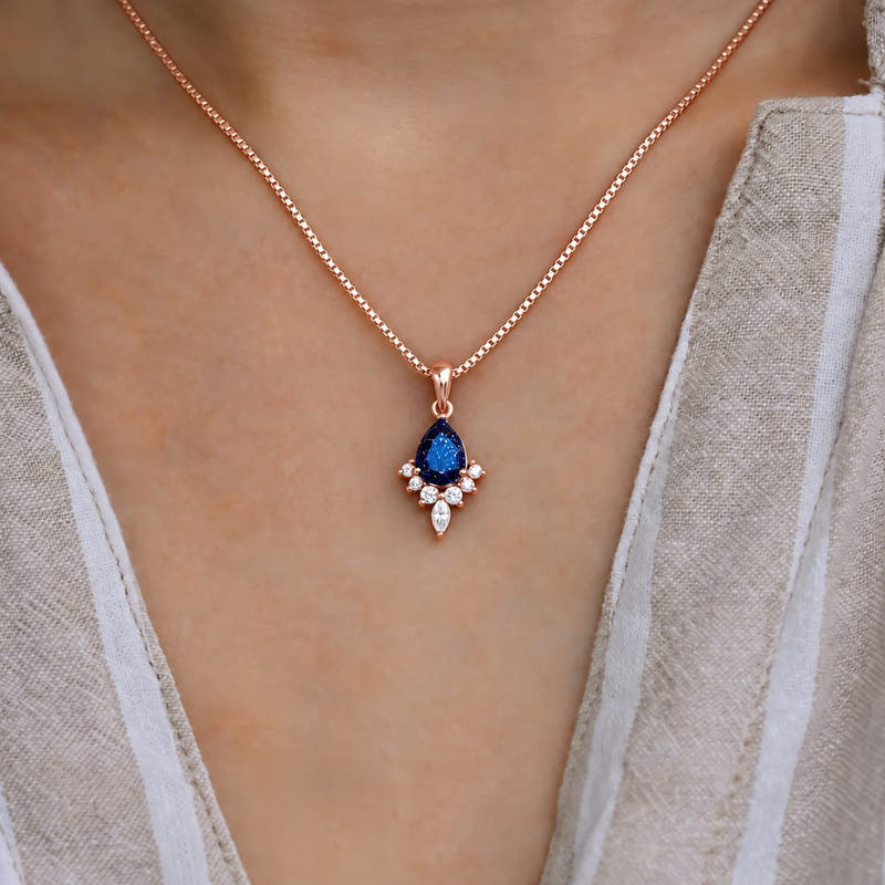 Pear blue sandstone pendant necklace on a rose gold box chain, worn at the neck